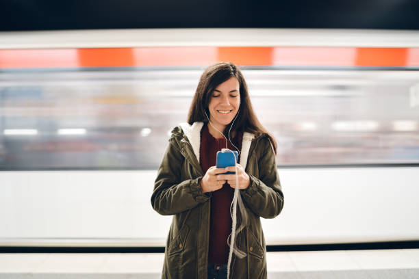 istock Checking social media on phone at subway station 1271777976