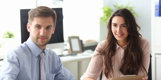 istock Smiling woman with partner in conference room 1271778111