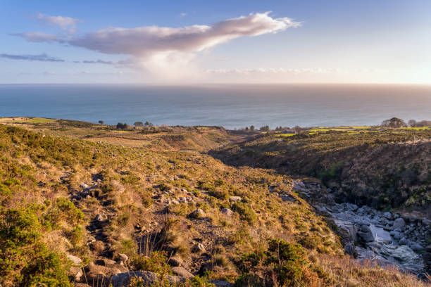 istock Stream in a mountain valley, flowing between rocks with Irish Sea in the background 1271782510