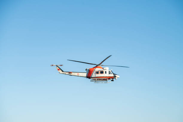 istock Coast Guard Helicopter flying with clear blue sky as background 1271787602