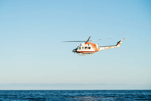 istock Coast Guard Helicopter flying with clear blue sky as background 1271788665