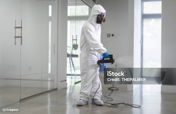 Office Sanitation By Professional Worker Coronavirus Pandemic Stock Photo - Download Image Now