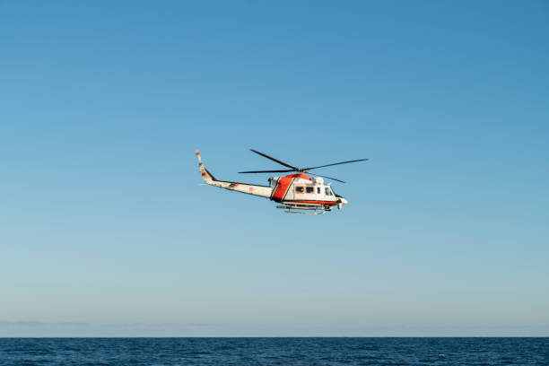 istock Coast Guard Helicopter flying with clear blue sky as background 1271788957