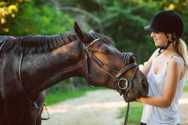 istock Happy woman hugging her horse 1271789305