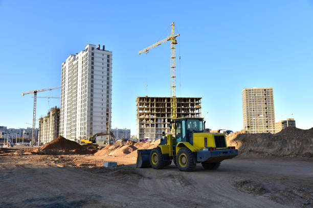 istock Front-end loader and excavator on road work. Tower crane in action at construction site. Earth-moving heavy equipment for road work. Construction machinery for public works, civil engineering 1271791700