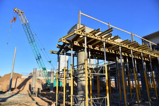 istock Roundabout and traffic bridge construction. Construction highway ramps and bridgeworks. Crane for formwork on bridge project works. Road work on traffic highway, road intersection junction and freeway 1271792844