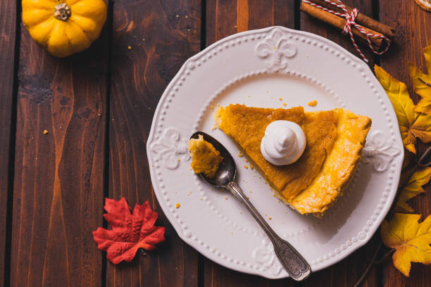 istock Thanksgiving holiday pumpkin pie with whipped topping 1271792916