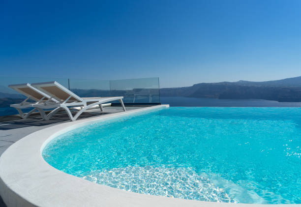 istock Lounge chair and pool over Santorini caldera 1271793096