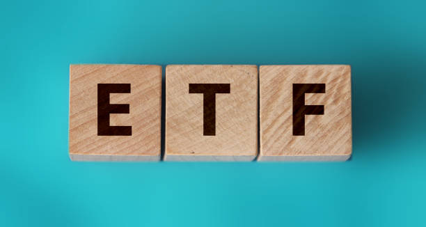 ETF, Exchange Traded Fund, realtime mutual index fund that can trade in equity stock market, cube wooden block with alphabet building the word ETF on aquamarine blue paper ETF, Exchange Traded Fund, realtime mutual index fund that can trade in equity stock market, cube wooden block with alphabet building the word ETF on aquamarine blue paper. exchange traded fund stock pictures, royalty-free photos & images