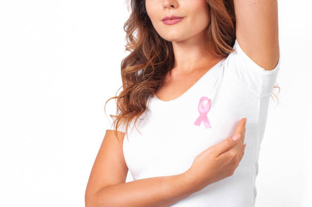 woman in white t-shirt with pink ribbon supporting breast cancer awareness campaign - t shirt shirt pink blank imagens e fotografias de stock