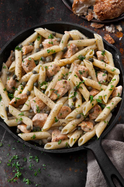 istock Grilled Chicken Piccata with Penne Pasta and Fresh Artisan Bread 1271793966