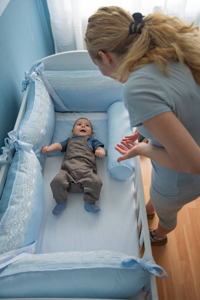 istock Mother putting her baby to sleep. 1271794229