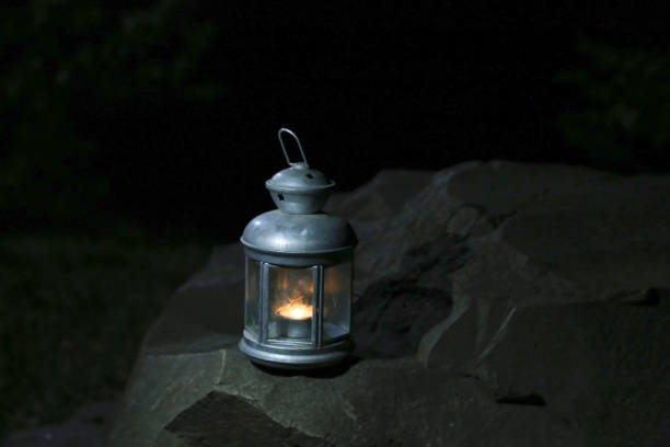 istock Burning lantern on a stone in the moonlight 1271795703