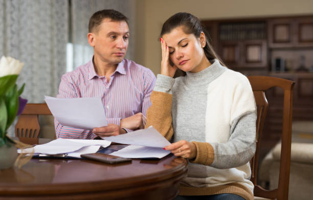 istock Couple filling out financial documents 1271799870
