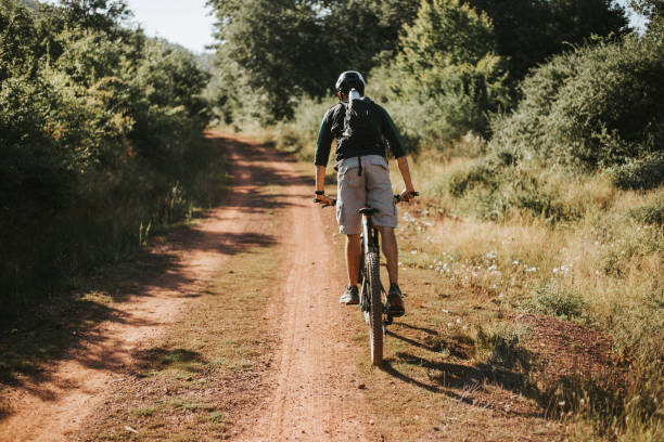 istock Bearded man is riding bicycle in the woods. 1271799936
