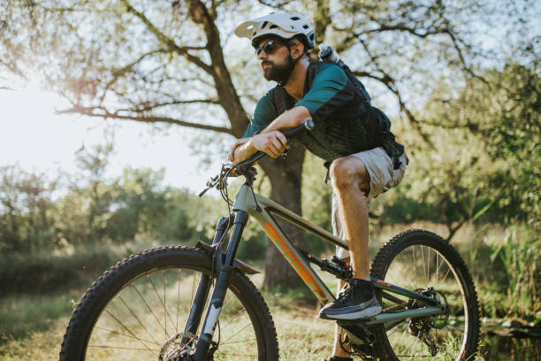 istock Portrait of a bearded man siting on a bicycle. 1271801050