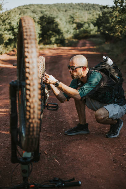 istock Man is repairing his bicycle 1271801808