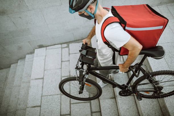 istock Delivery man moving downstairs entering subway 1271801829