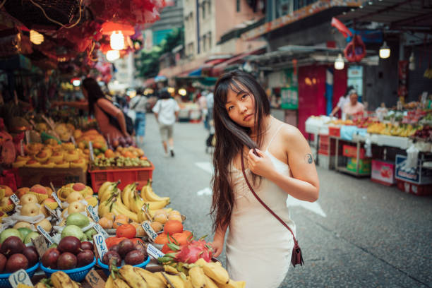 istock Asian woman at vegetable stand. 1271802733