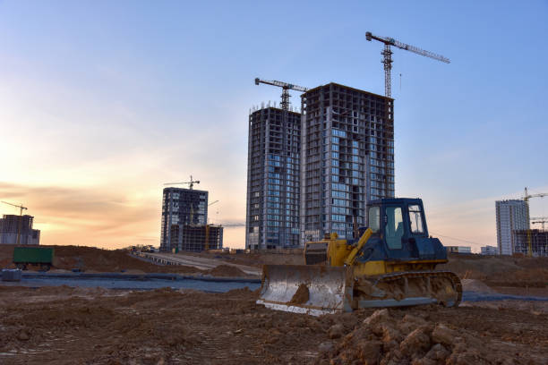 istock Dozer at open pit mining on sunseet background. Bulldozer for land clearing, grading, pool excavation, utility trenching and foundation digging. Earth-moving equipment 1271803352