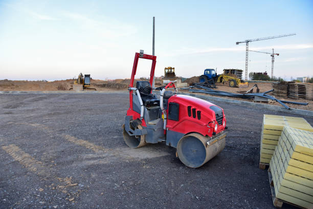 istock Paving roller machine during road work. Mini road roller at construction site for paving works. Screeding the sand for road concreting. Asphalt pavement is layered over concrete pavement 1271804622