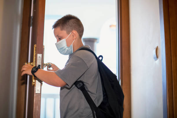 istock Boy with schoolbag going home from school 1271808652