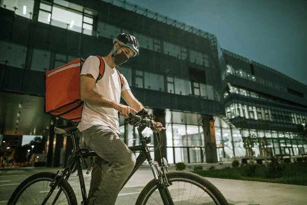 istock Delivery man checking directions on mobile phone 1271810693