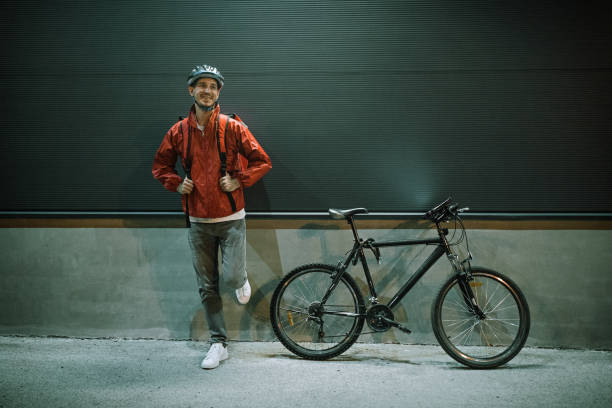 istock Happy delivery man leaning on wall by bicycle at night 1271813282