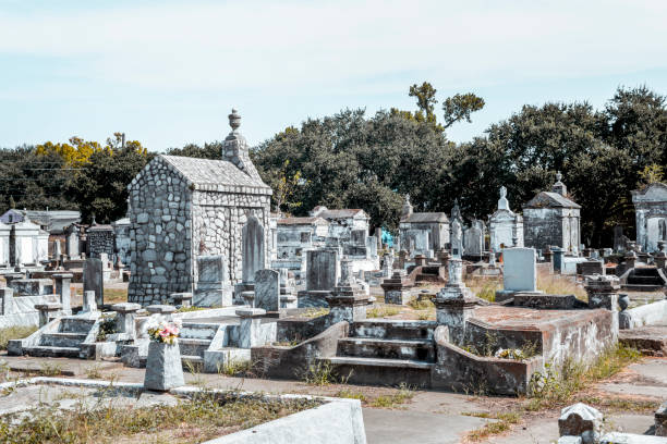 Old Cemetery in New Orleans A sunny day in an old cemetery with ruined ornamental tombs - Lafayette Cemetery No. 2 in New Orleans. lafayette louisiana photos stock pictures, royalty-free photos & images