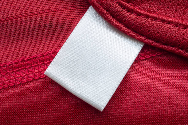 istock White blank laundry care clothes label on red polyester sport shirt background 1271842569