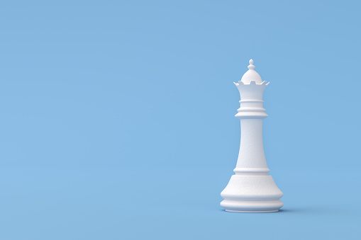 Pieza de ajedrez de la reina sobre fondo azul photo