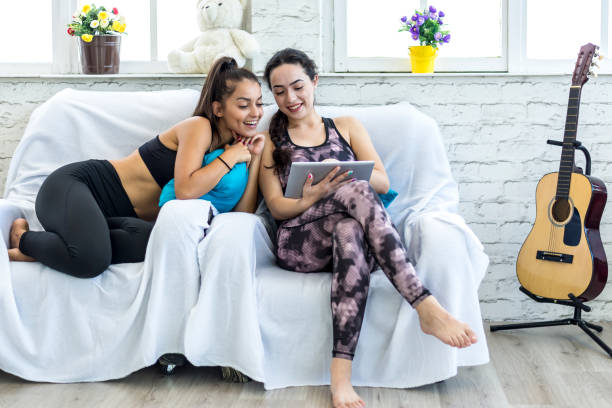Two student friends, dressed in sportswear, in their quarters