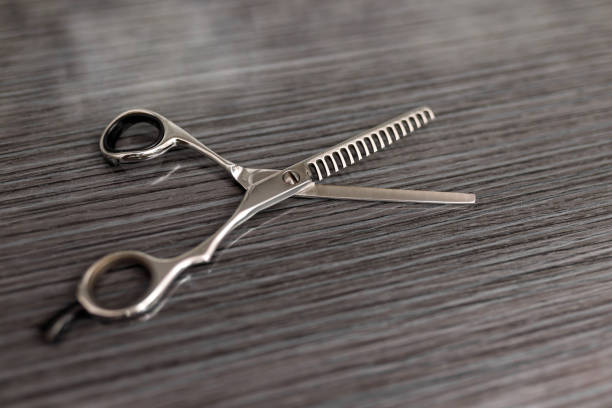 istock Hair thinning scissors on table in professional hairdressing salon. Selective focus 1271849636
