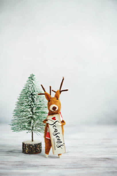 istock Bright Christmas Background with Tree and Cute Felt Reindeer 1271851463