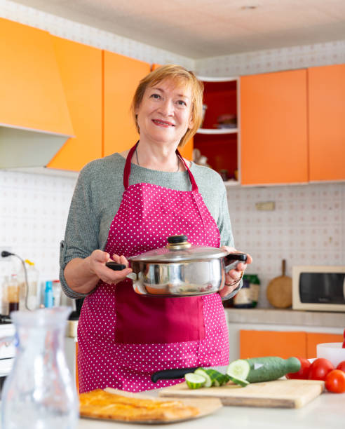 istock Senior housewife cooking at kitchen 1271859367
