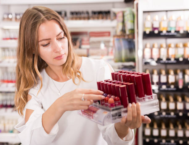istock Girl holding lipsticks in makeup boutique 1271859552