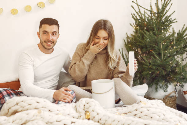 istock Couple spend time at home with christmas decorations 1271860591