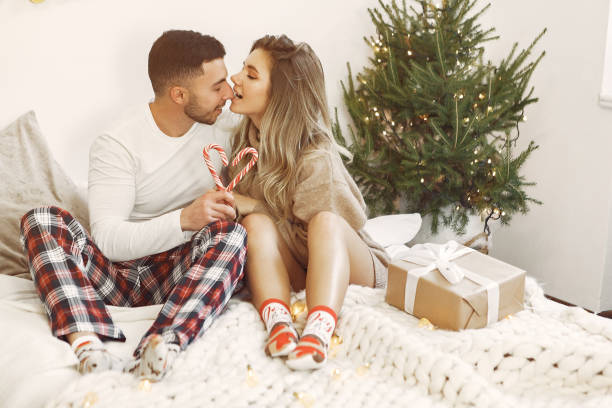 Couple spend time at home with christmas decorations stock photo