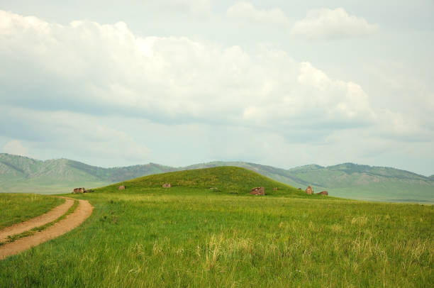 istock A field road winds through the steppe, skirting the hills. 1271870275