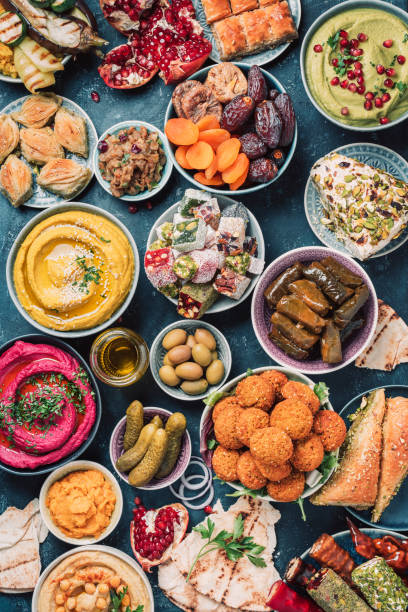 istock Mediterranean assorted appetizers, abundance concept. Top view. Arabic traditional cuisine. Middle Eastern colorful hummus, pita, falafel, dolma, baklava, halva, rahat lokum, sherbet, dried fruits 1271870390