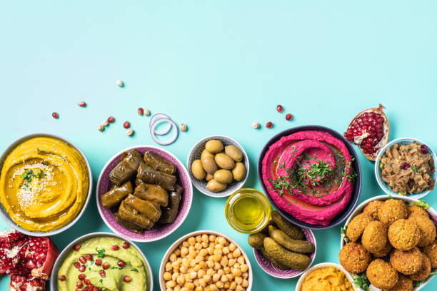 istock Mediterranean appetizer concept. Arabic traditional cuisine. Middle Eastern meze with pita, olives, hummus, stuffed dolma, falafel balls, pickles, babaganush, vegetables, pomegranate, eggplants 1271870422