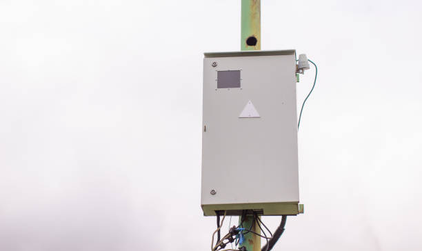 istock White electric box on a pole outside the house. 1271872678
