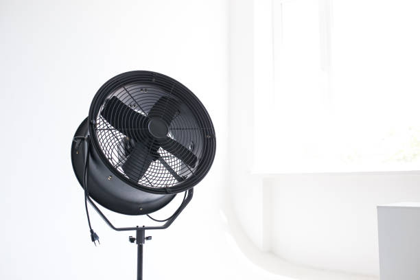 Black powerful fan in the white room. Studio isolated. Close-up.