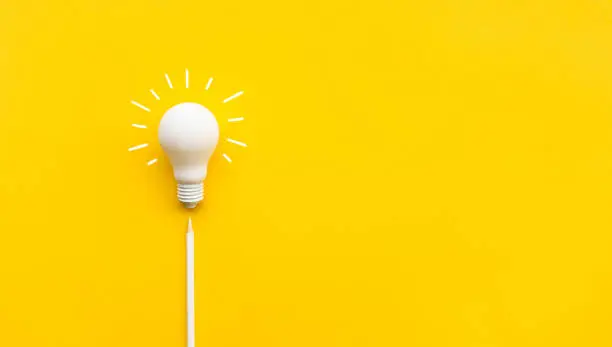 Photo of Business creativity and inspiration concepts with lightbulb and pencil on yellow background