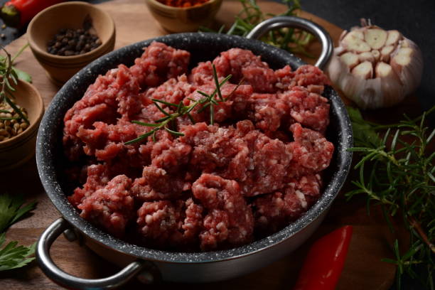 istock Minced beef. Ground meat with ingredients for cooking on black background 1271877141