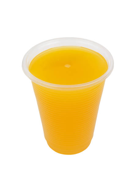 istock Orange juice in plastic cup isolated 1271877401