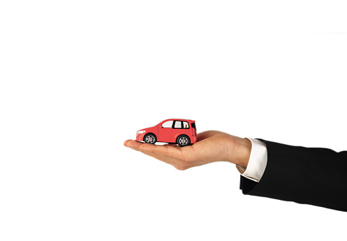 Businessman holding toy car
