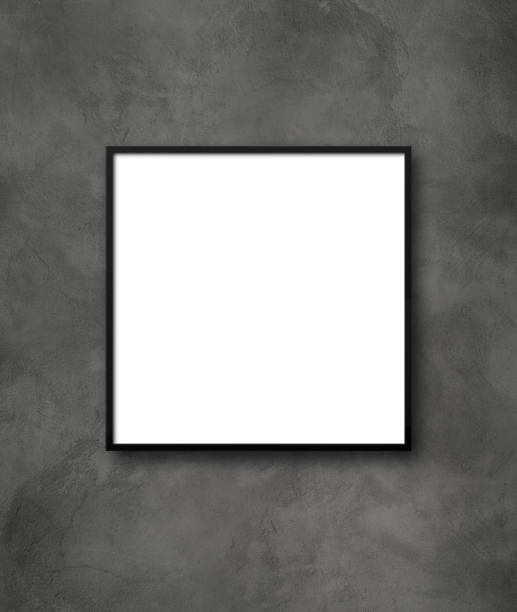 istock Black square picture frame hanging on a dark concrete wall 1271879358