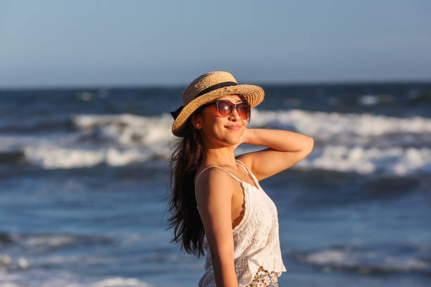 istock Beautiful young woman relaxing at sunset beach 1271880178