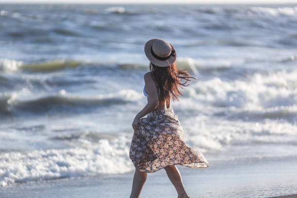 istock Beautiful young woman relaxing at sunset beach 1271880266